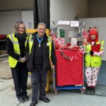 Image shows Lucy Danger, CEO of EMERGE, Eamonn O'Neal, High Sheriff of Greater Manchester and Sally a FareShare Plus volunteer at the FareShare Plus Valentine's stand