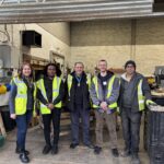 Image shows Eamonn O'Neal, High Sheriff of Greater Manchester with staff and volunteers from Touch Wood