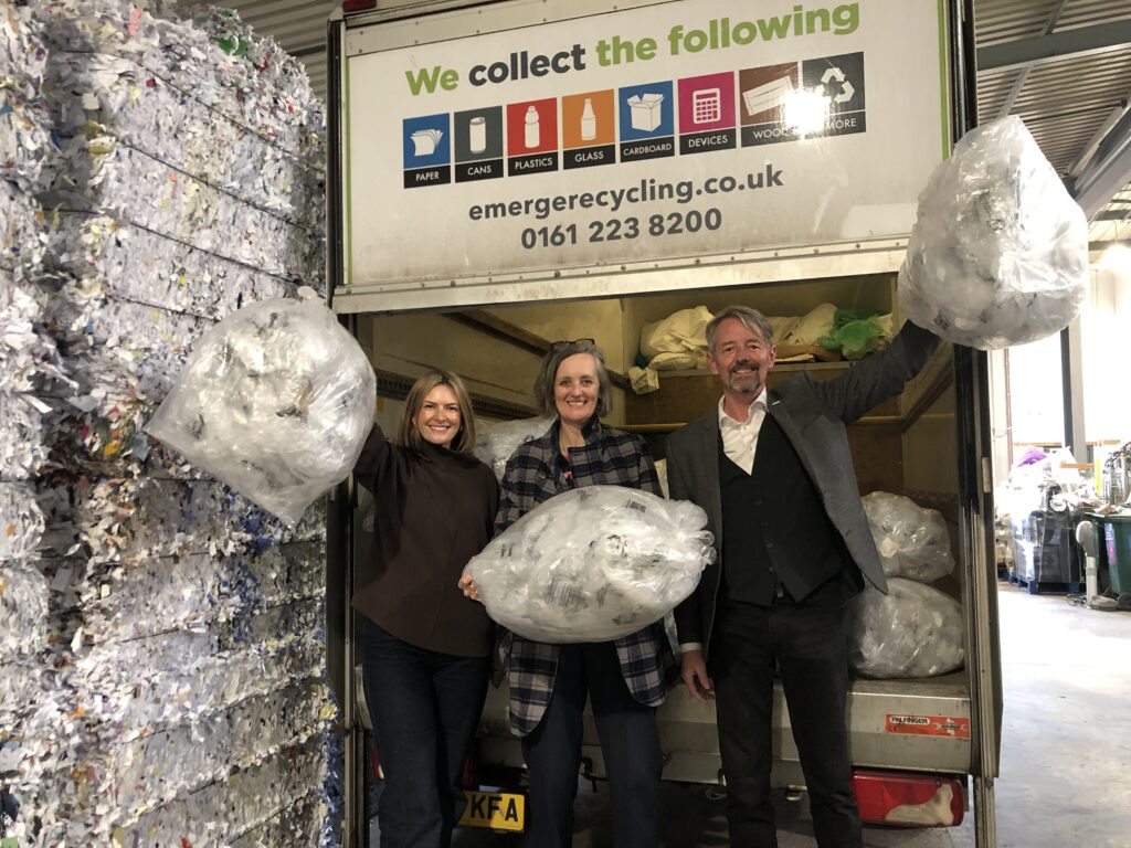 Image shows Lucy Danger & Mike Taylor from Emerge and Zoe from DUO UK standing behind a van holding bags of LDPE up and smiling at the camera 