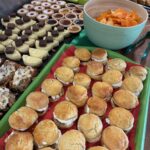 Image shows a table laden with food for a buffet