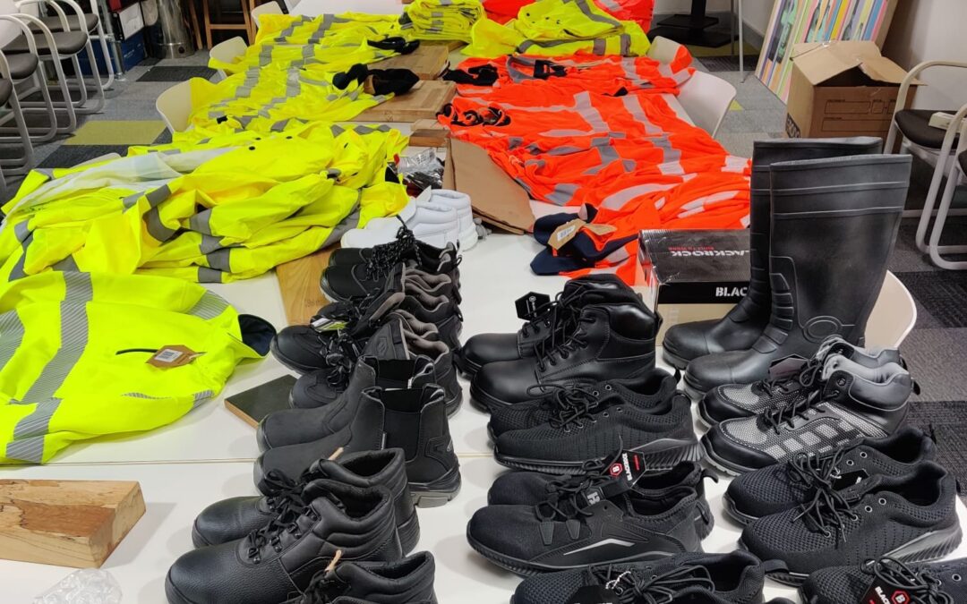 Image shows donated PPE equipment laid out along a board room table at EMERGE Recycling