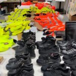 Image shows donated PPE equipment laid out along a board room table at EMERGE Recycling